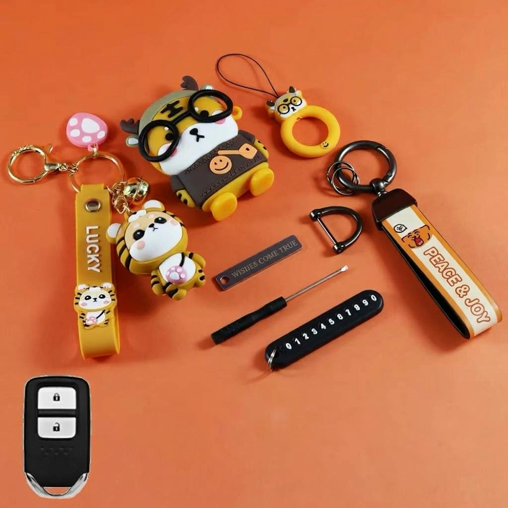Tiger key fob cover with wrist straps, charms, and keychain accessories on orange background
