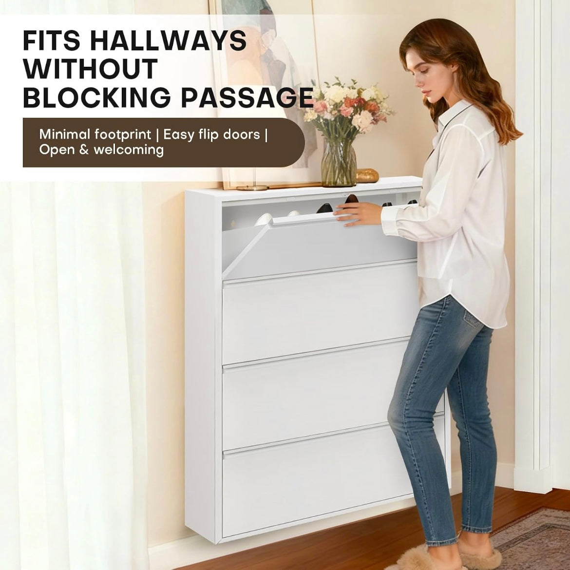 Woman opening the top flip-down drawer of a white slim shoe cabinet in a hallway.