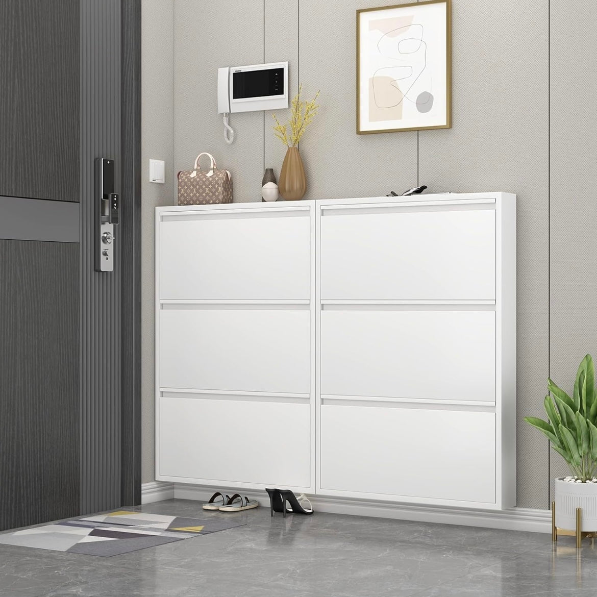 Two white slim shoe cabinets mounted side by side beside a front door.