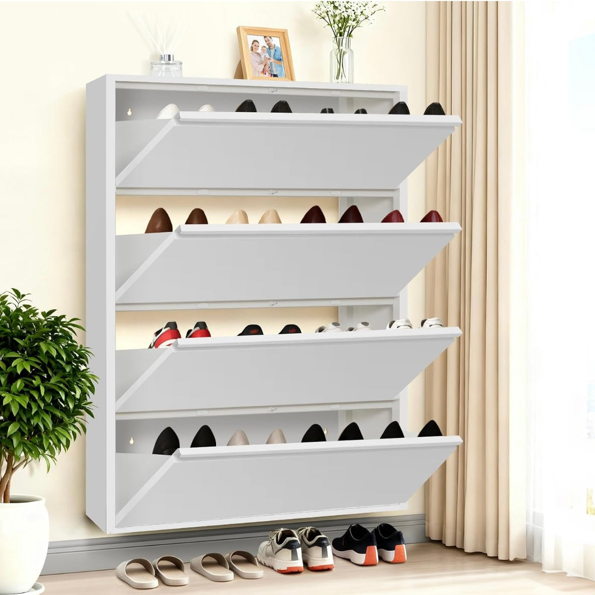 White slim shoe cabinet with four open tilt-out drawers holding everyday footwear.