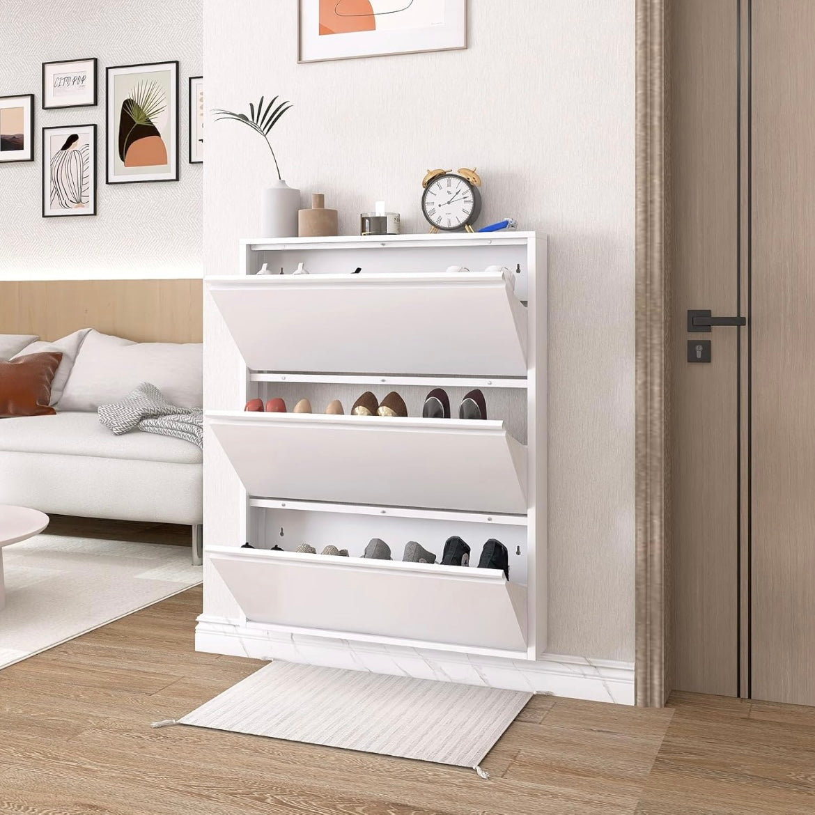 White three-drawer shoe cabinet with flip-down compartments open and shoes organized inside.