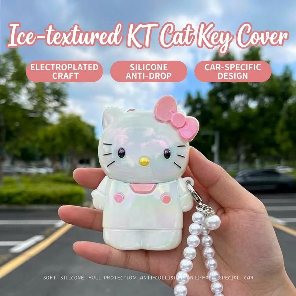 KT cat car key fob cover with pink bow, shimmering white finish, and pearl-style keychain.