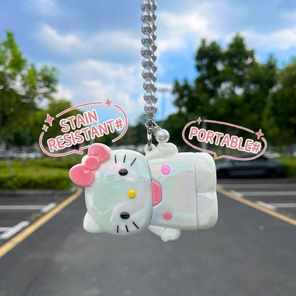 White KT cat key fob cover with pink bow hanging from a pearl-style beaded keychain.
